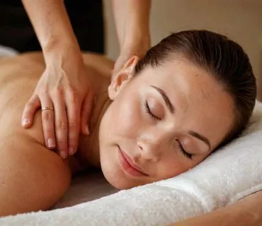A topless woman getting a back massage